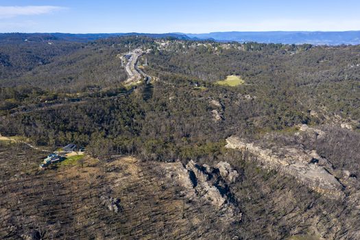 Aerial view of the Great Western Highway running through forest burnt by bushfires at Mount Victoria in The Blue Mountains in New South Wales in Australia