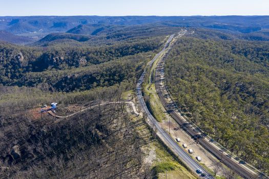 Aerial view of the Great Western Highway running through forest burnt by bushfires at Mount Victoria in The Blue Mountains in New South Wales in Australia