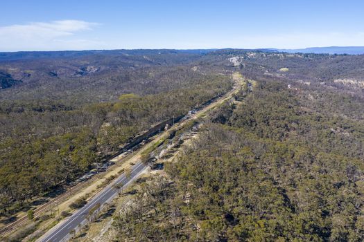 Aerial view of the Great Western Highway running through forest burnt by bushfires at Mount Victoria in The Blue Mountains in New South Wales in Australia