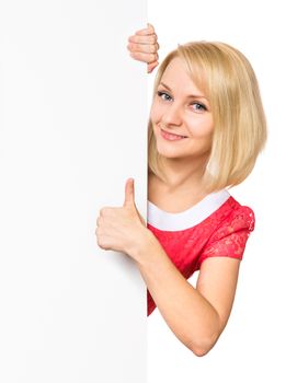 Portrait of happy smiling young woman, showing empty blank signboard with copyspace. Businesswoman holding big white banner, isolated on white background.