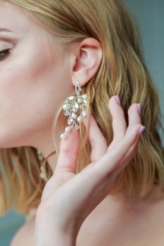 .Bride straightens an earring before the wedding ceremony