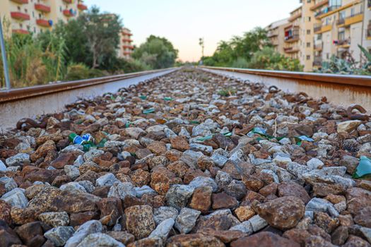 train tracks with sky trees and buildings