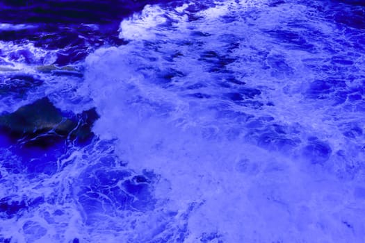 The ocean crashing on rocks with white waves in Kiama New South Wales taken in Infrared