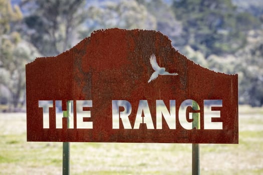The Range metal sign in a green field in regional Australia
