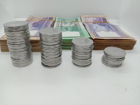 Bangladeshi bank note bundle and coin on white background