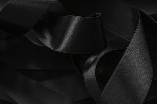 Black silk ribbon as background, abstract and luxury brand designs