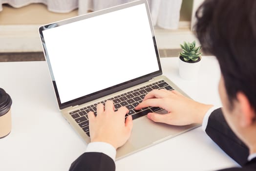 Work from home, Asian young businessman smile wearing suit video conference call or facetime by laptop computer sitting and listening to teammates explained on desk at home office