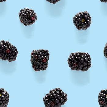 Bramble Seamless pattern. Fresh blackberry seamless pattern. Square pattern with fresh wild berries isolated on blue background. flat lay.