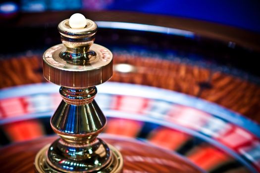 Roulette wheel in casino, gambling ads