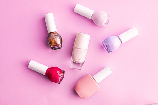 Nail polish bottles on pink background, beauty branding