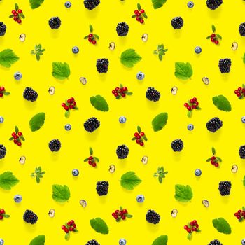 Creative seamless pattern of wild berries, blackberry, blueberry, lingonberry and bramble. modern seamless pattern on yellow backgriund made from autumn forest wild berries. Forest berries mix