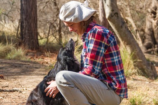 portrait of a woman farm worker with her dog