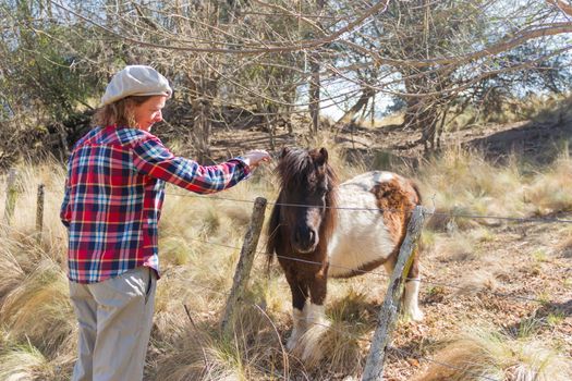 woman who works in the field with ponies