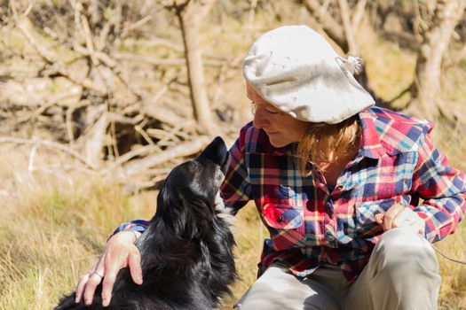 portrait of a woman farm worker with her dog