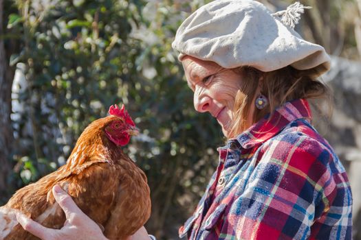 portrait of an Argentine farm worker woman with a hen