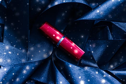 Red lipstick on blue silk and shiny glitter background, luxury make-up and beauty cosmetics