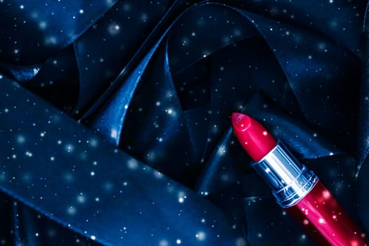 Red lipstick on blue silk and shiny glitter background, luxury make-up and beauty cosmetics