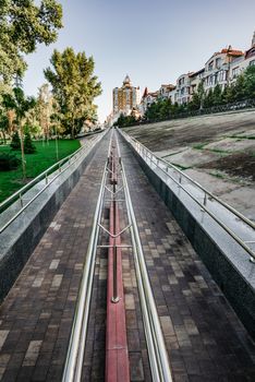 A long metal ramp for handicapped people, bicycles and people with strollers, near Natalka Park in the Obolon district of Kiev, Ukraine.