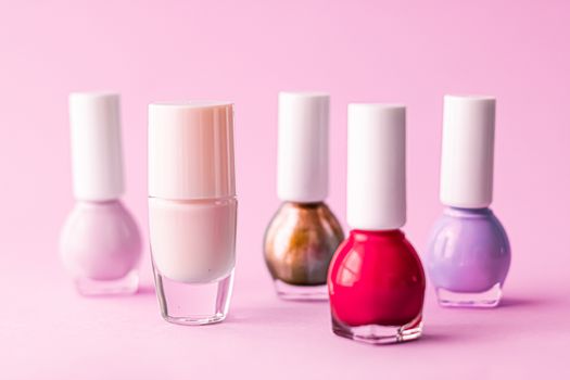 Nail polish bottles on pink background, beauty branding