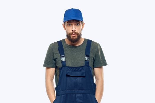 Worker man uniform delivery service emotions studio light background. High quality photo