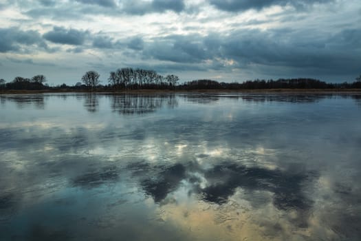 The reflection of clouds in the ice on the lake, winter view