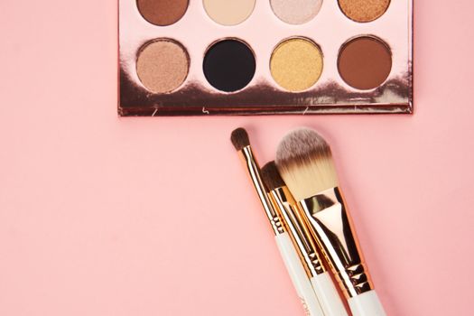 eyeshadow makeup brushes collection professional cosmetics accessories on pink background. High quality photo