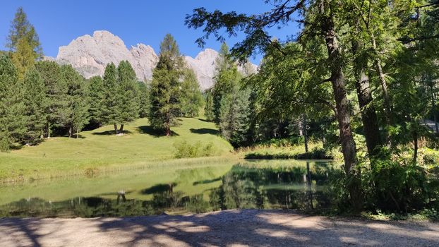 Val Gardena, Italy - 09/15/2020: Scenic alpine place with magical Dolomites mountains in background, amazing clouds and blue sky  in Trentino Alto Adige region, Italy, Europe