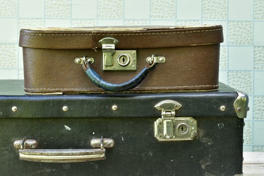 two old suitcases, black large and small brown close-up
