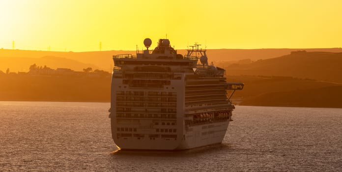 Weymouth Bay, United Kingdom - July 6, 2020: Beautiful panoramic shot of P&O cruise ship Ventura anchored in Weymouth Bay at sunset