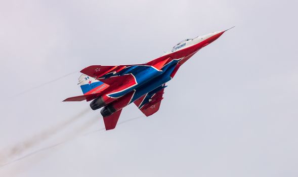 Barnaul, Russia - September 19, 2020: A low angle close-up shot of Strizhi MiG-29 fighter jet performing stunts during an aeroshow.
