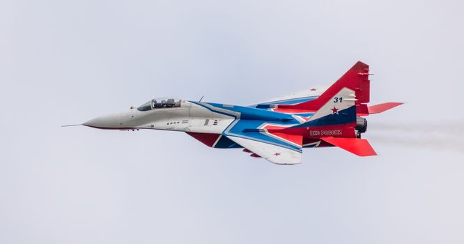 Barnaul, Russia - September 19, 2020: A close-up shot of Strizhi MiG-29 fighter jet performing stunts during an aeroshow.