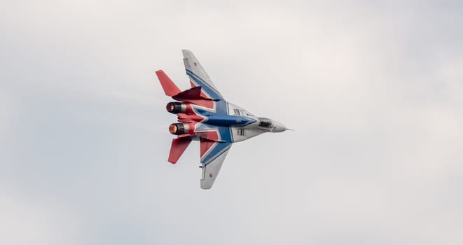 Barnaul, Russia - September 19, 2020: A low angle close-up shot of Strizhi MiG-29 fighter jet performing stunts during an aeroshow.
