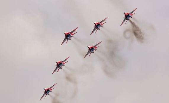 Barnaul, Russia - September 19, 2020: A low angle shot of Strizhi MiG-29 fighter jet squadron performing stunts during an aeroshow.