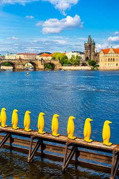 Art object march of yellow penguins. Weird art statues of Prague.