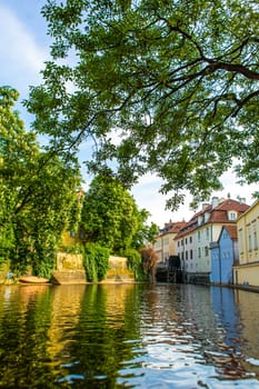 The architecture of the strago city of Prague. River channel in the city. Streets of old Europe, cityscape.