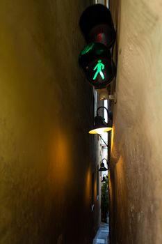 The architecture of the strago city of Prague. The narrowest street in Europe. The passage between buildings for one person, regulated by traffic lights.
