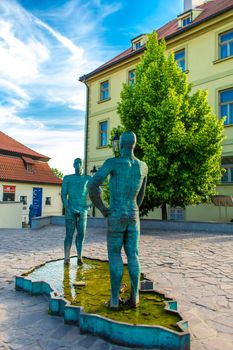 Sculpture-fountain Peeing Men in Prague. A fountain formed by two figures of peeing men standing opposite each other.