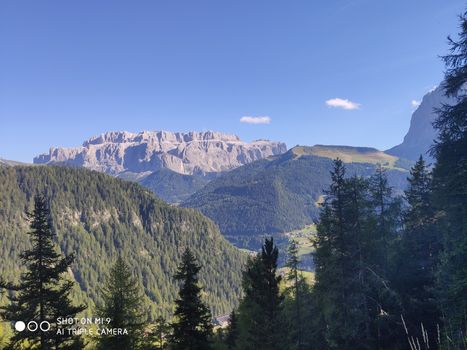 Val Gardena, Italy - 09/15/2020: Scenic alpine place with magical Dolomites mountains in background, amazing clouds and blue sky  in Trentino Alto Adige region, Italy, Europe