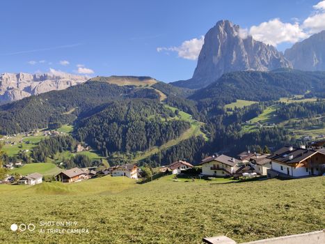 Val Gardena, Italy - 09/15/2020: Scenic alpine place with magical Dolomites mountains in background, amazing clouds and blue sky  in Trentino Alto Adige region, Italy, Europe