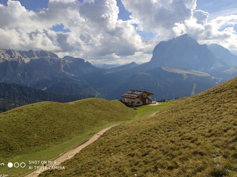 Val Gardena, Italy - 09/15/2020: Scenic alpine place with magical Dolomites mountains in background, amazing clouds and blue sky  in Trentino Alto Adige region, Italy, Europe