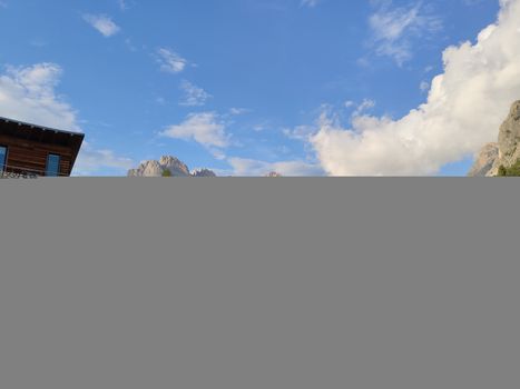 Val Gardena, Italy - 09/15/2020: Scenic alpine place with magical Dolomites mountains in background, amazing clouds and blue sky  in Trentino Alto Adige region, Italy, Europe