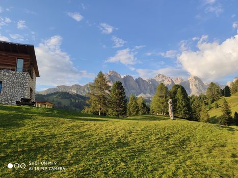 Val Gardena, Italy - 09/15/2020: Scenic alpine place with magical Dolomites mountains in background, amazing clouds and blue sky  in Trentino Alto Adige region, Italy, Europe