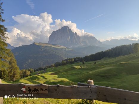 Val Gardena, Italy - 09/15/2020: Scenic alpine place with magical Dolomites mountains in background, amazing clouds and blue sky  in Trentino Alto Adige region, Italy, Europe