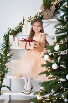 Little girl in princess dress celebrates christmas. Christmas magic fairy tale. Happy childhood.