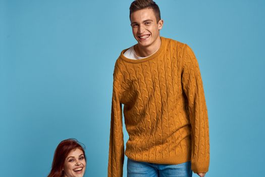 Man in sweater on blue background and woman cropped view of emotion. High quality photo
