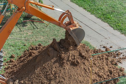 Minsk, Belarus - September 12: Tractor digs a pit to repair a ruptured heating pipe