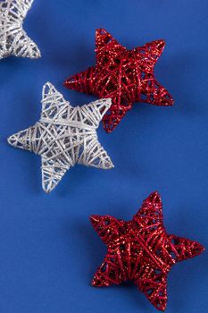 Brilliant red silver Christmas star on blue background. Use for New Year's greetings. Minimal banner, copy space for text, flatlay.