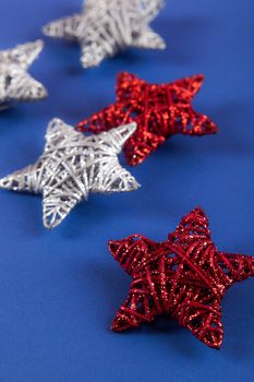 Brilliant red silver Christmas star on blue background. Use for New Year's greetings. Minimal banner, copy space for text, flatlay.