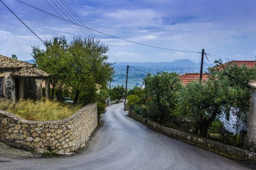 route that passes through a small town on the island of zakynthos in the background you can see the countryside and mountains