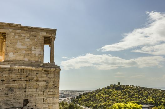 close-up view of the buildings of the Acropolis and behind the monument to Philopappos on the hill of the same name athens